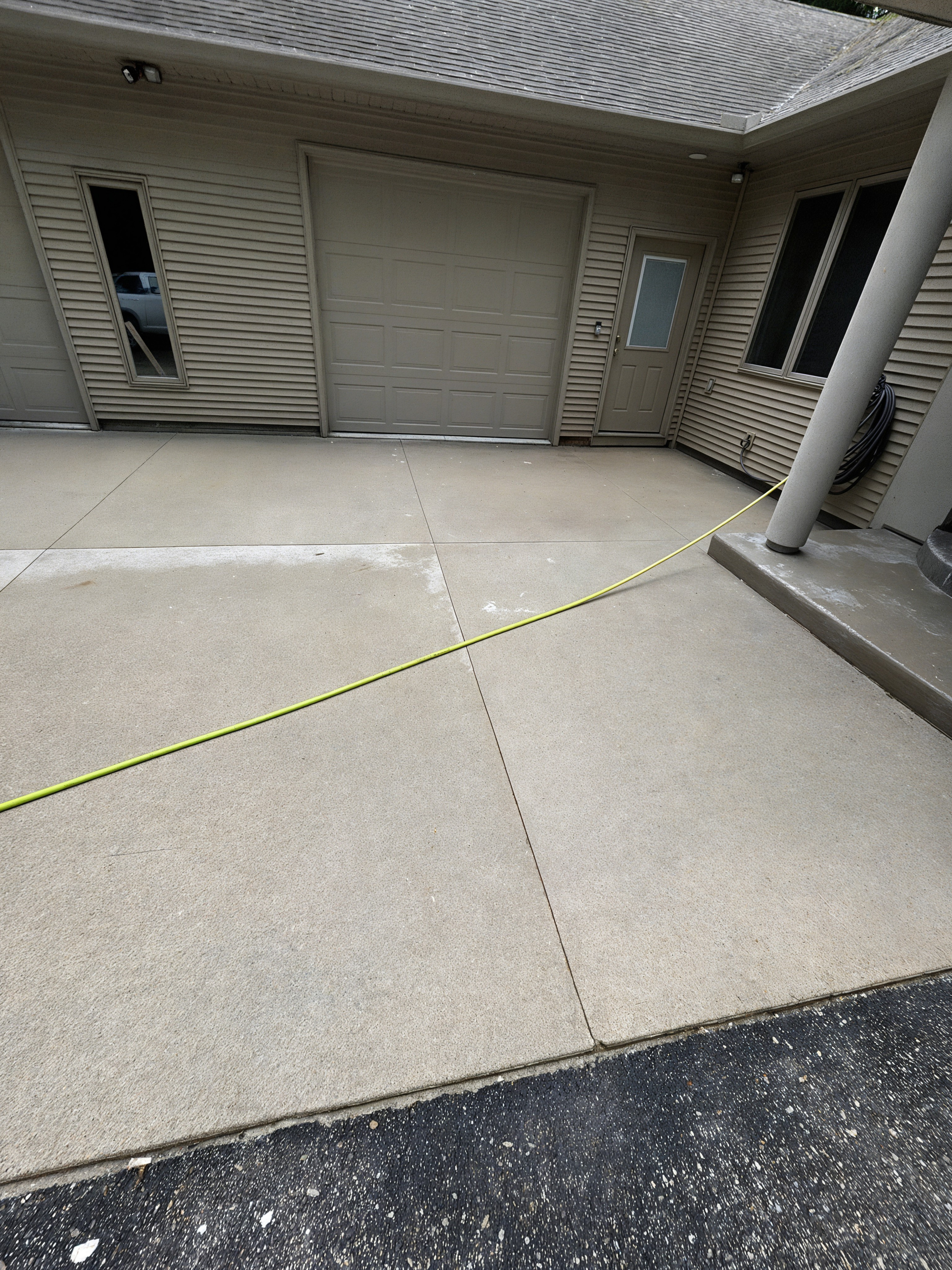 After: driveway cleaned near garage
